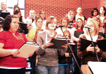 Leslie Schaefer, Paige Boche, and Alyssa Larson all sing for the students who enjoyed a delicious holiday dinner.