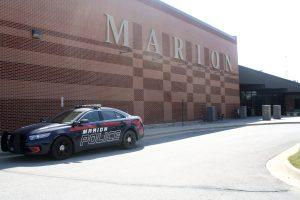 A Marion Police car parked outside of MHS while the officer is inside.