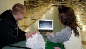 Marlie Neff and Jacob Klostermann watch "What does a fox say?" on youtube in the cafeteria. 