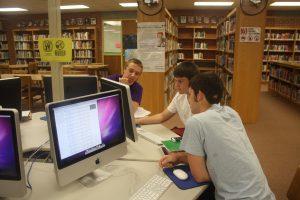 Eli Matthess, Ryan Anderson, and Jacob Deeter, all ‘16, work together in the library.