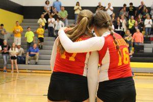 Two Marion High School volleyball players sharing a brief moment, displaying what high school sports should really be about