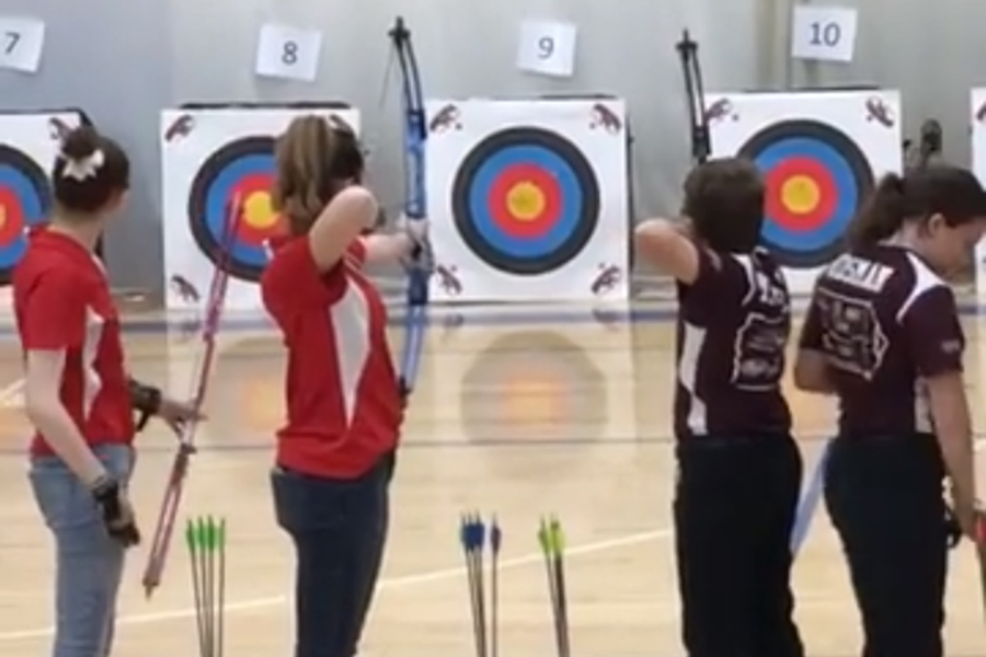 Cappra Svoboda and Madison Berry, both 18, compete in an archery tournament.