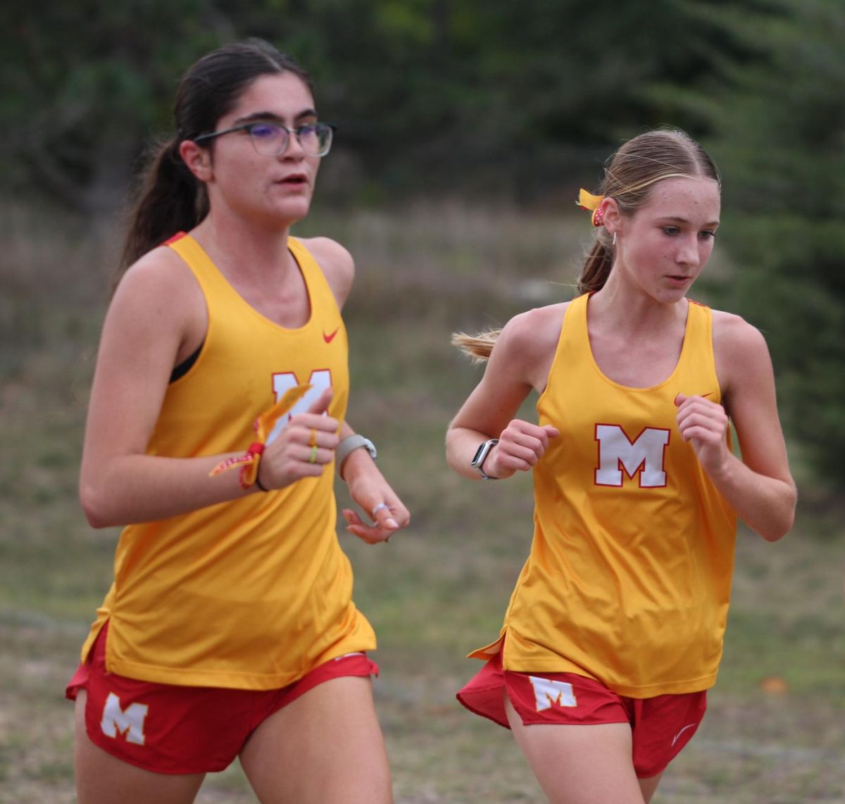 Kendall Orozco, senior, and Elise Moore, junior, give their all during a XC meet. 