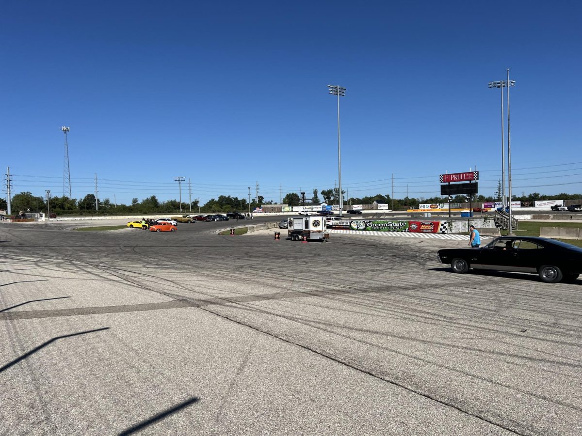 Two cars drive off after spending some quality time at Cars and Coffee.