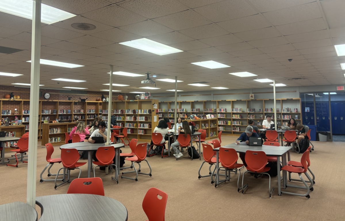 Students work quietly in the library to complete work. 