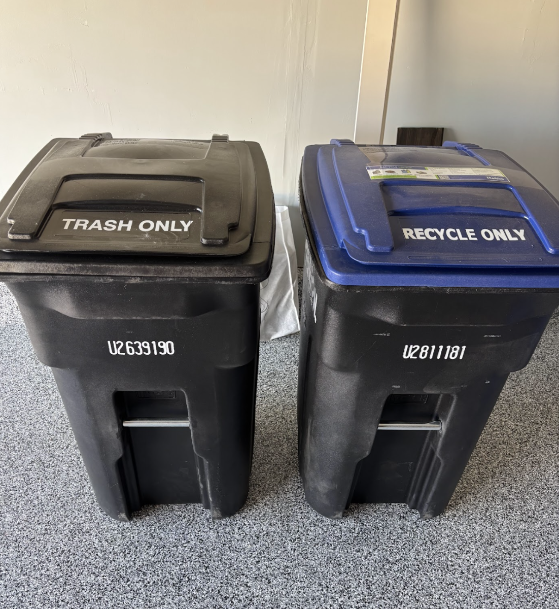 The new garbage carts are on wheels, significantly bigger, and better.