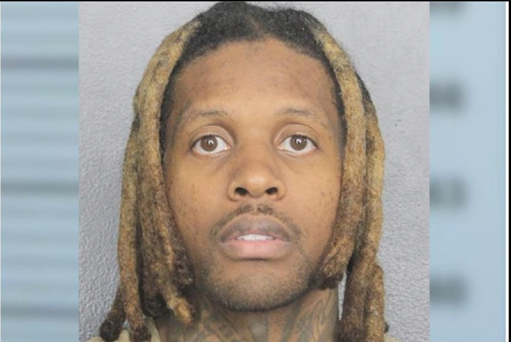 Durk is posing for his mugshot.