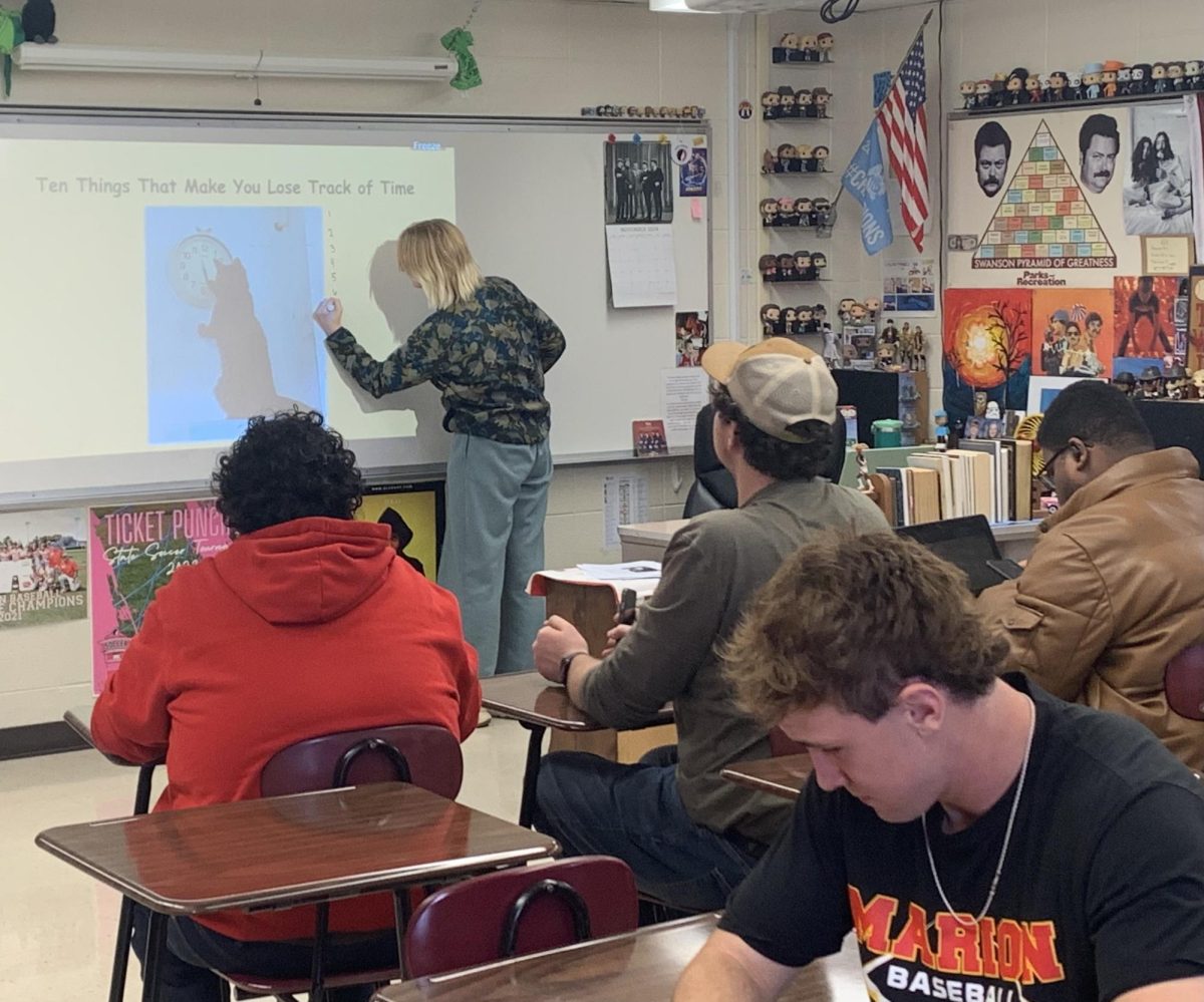 Student teacher, Gracie Erickson, teaches in front of Erik Trilk’s Senior English class.