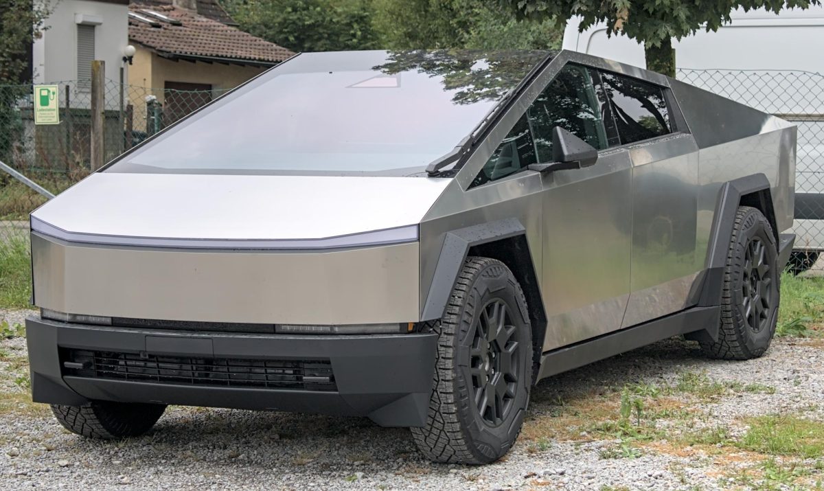 A Cybertruck is parked to show off its stainless steel build.