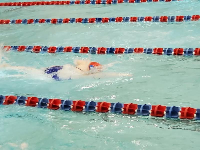 Grace Wittstruck is competing at the Washington Swim Tournament with her team.