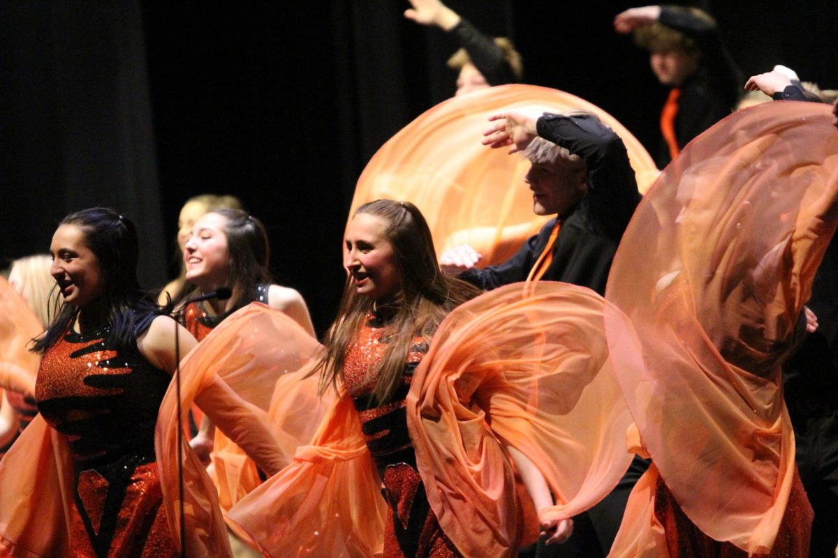 Avery Booms, '26, dances with the show choir during the Premiere Concert in the brand new Performing Arts Center.