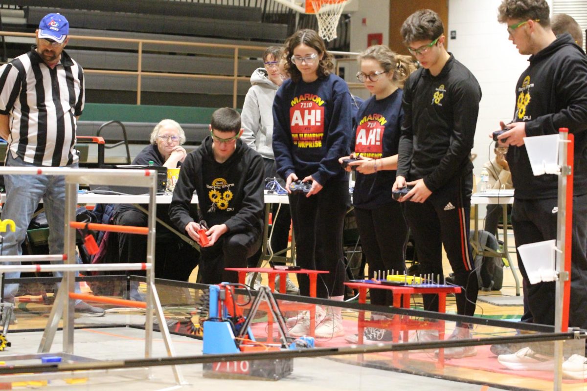 A group of robotics teammates run their robot at a meet at Harding Middle School.