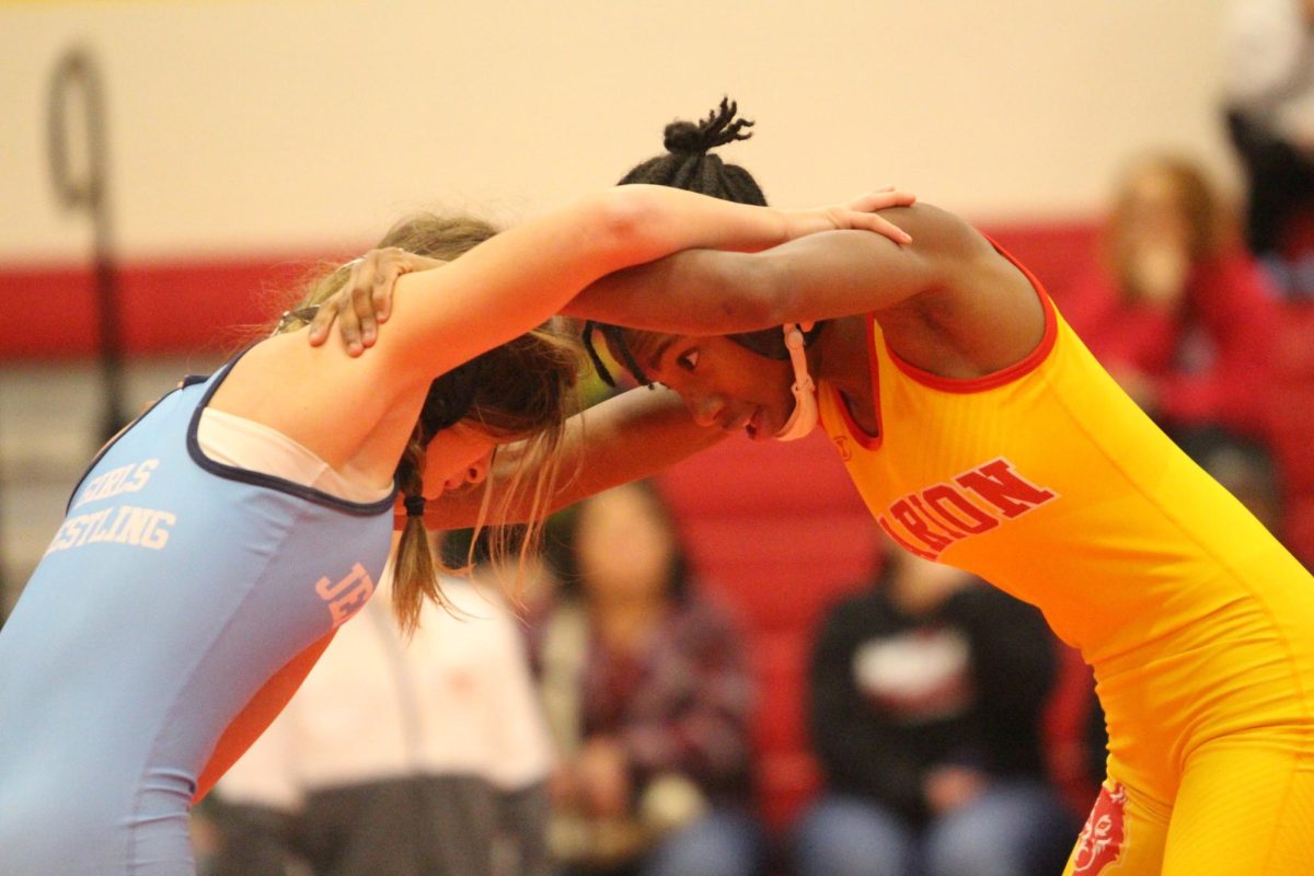 Wynter Morgan, '26, grapples with her opponent at a home wrestling meet. 