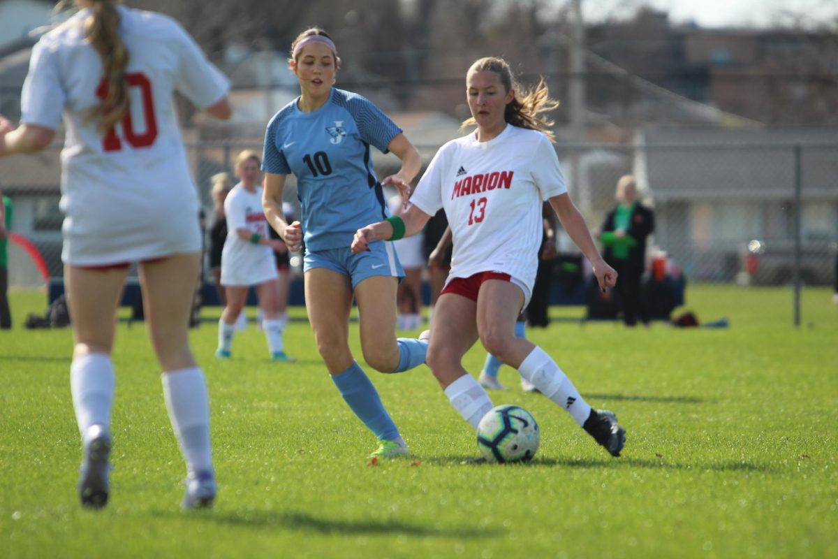 Kiaya Claypool, '27, dribbles the soccer ball during a match against Jefferson.