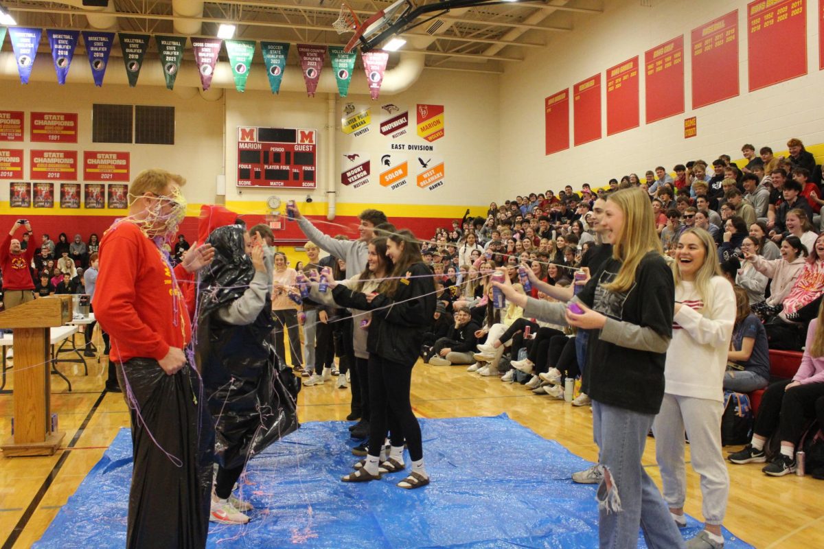 A group of students win the honor of spraying a chosen teacher with silly string because they grew on the ISASPs.