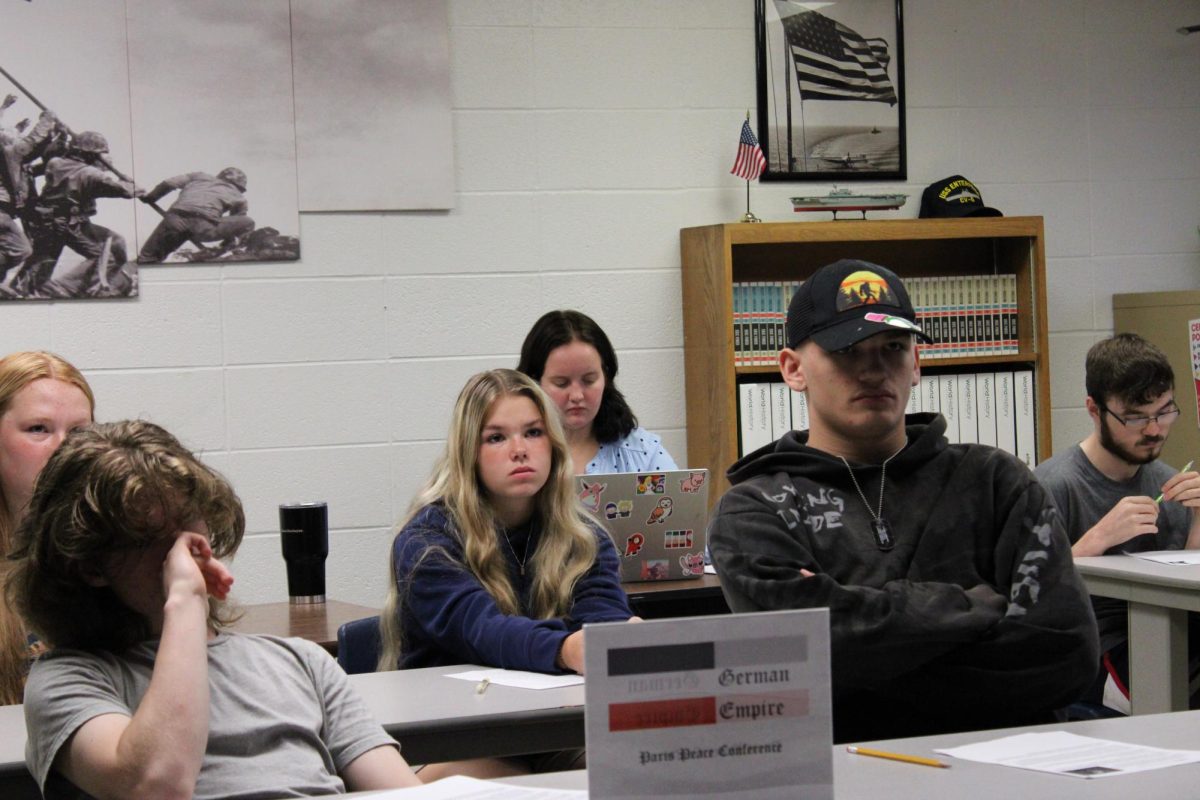 Aaron Blech’s WWII class acts out the Treaty of Versailles while taking notes.