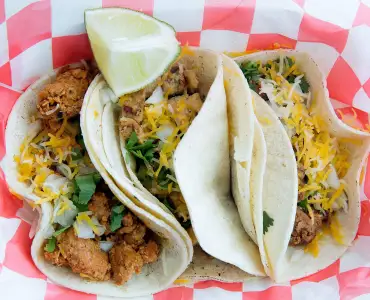 Moy’s Food from the Streets creates a diverse flavor palette with various dishes, such as tacos. 