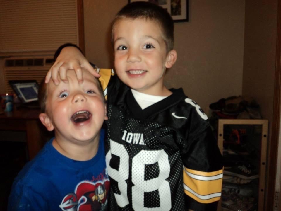 Young Devin Hendricks tussles with his little brother, Logan Hendricks.