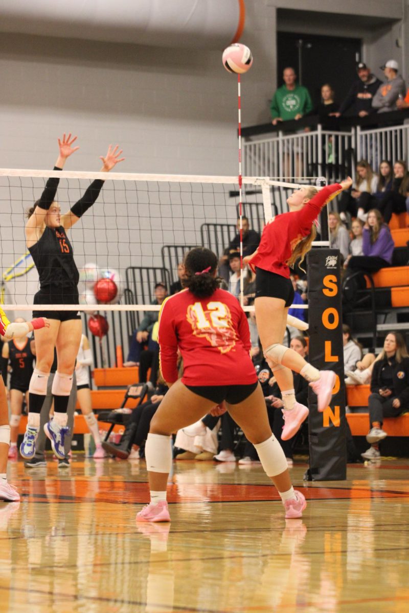 Braelin Wieseler, senior, completes a right side attack in the Sub-State game against Solon.