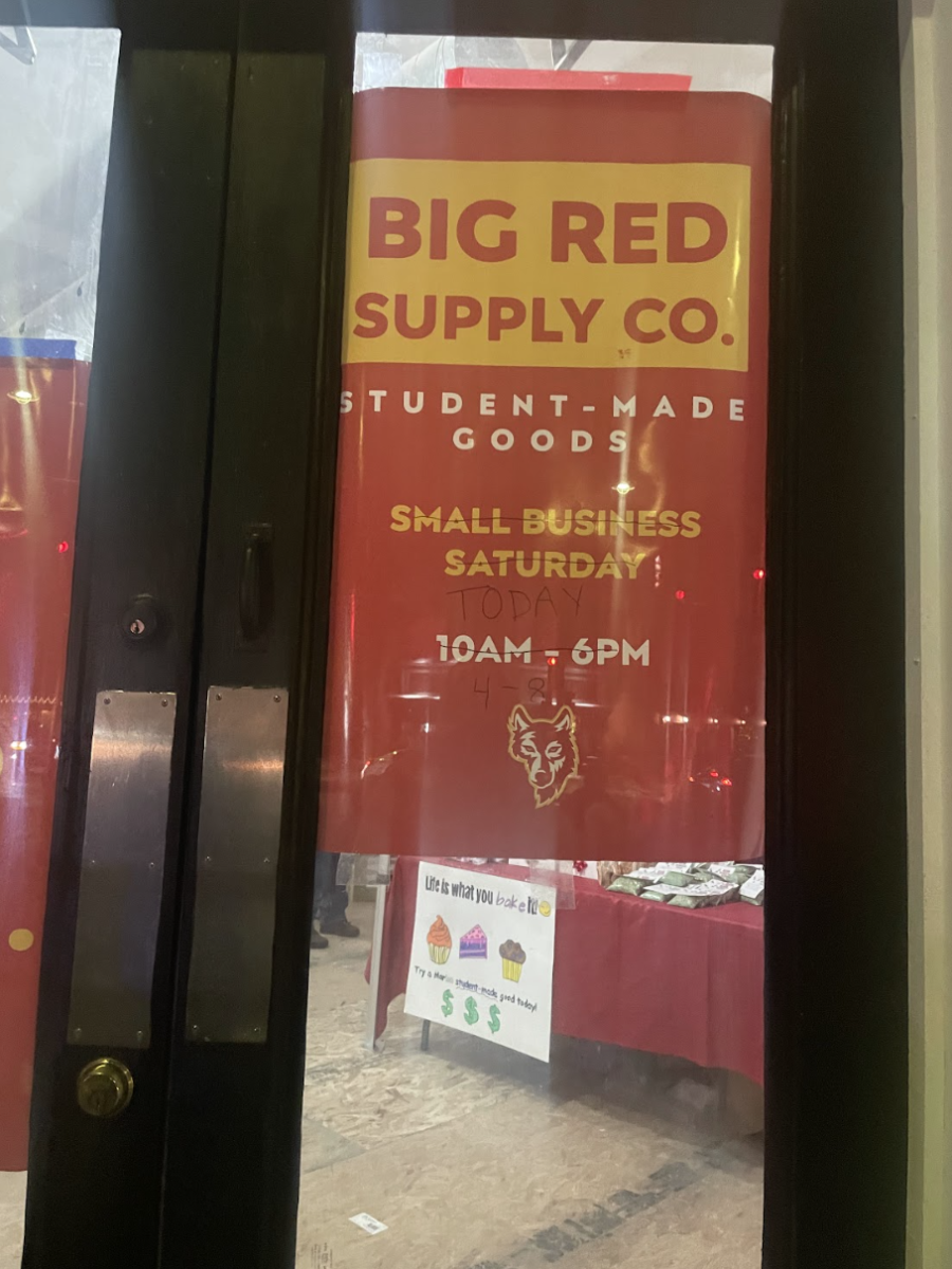 A sign located at 7th Ave and 10th St. promotes Big Red Supply Company, featuring both the old and updated times. 