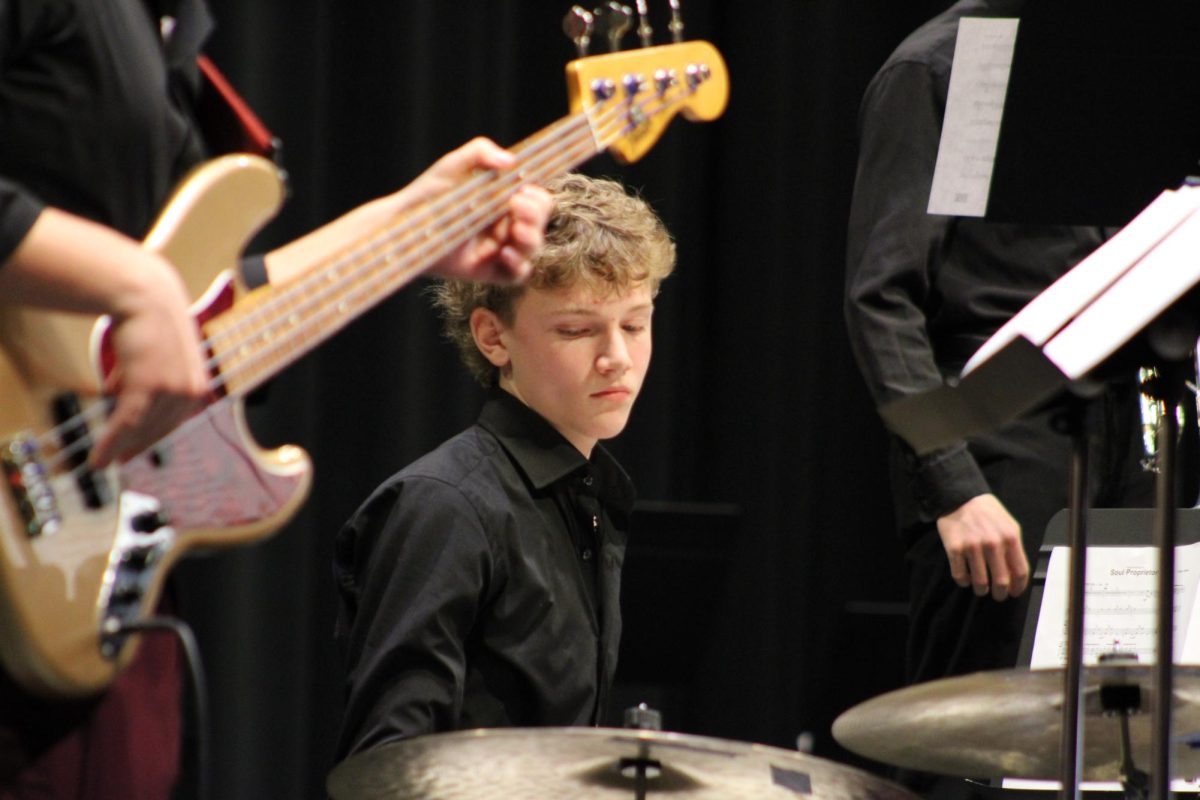 Zach Dyrland, '29, plays the drums during the jazz band premier concert.