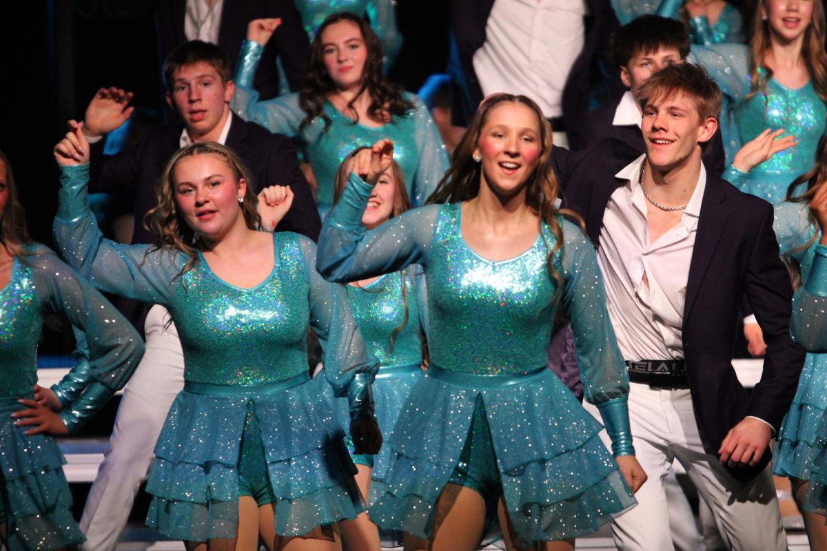 Alayna Wennekamp, '28, Lucy Hangartner, '26, and Brandon Hatfield, '26, dance at the Xavier Show Choir competition. This year's theme was all about the love!