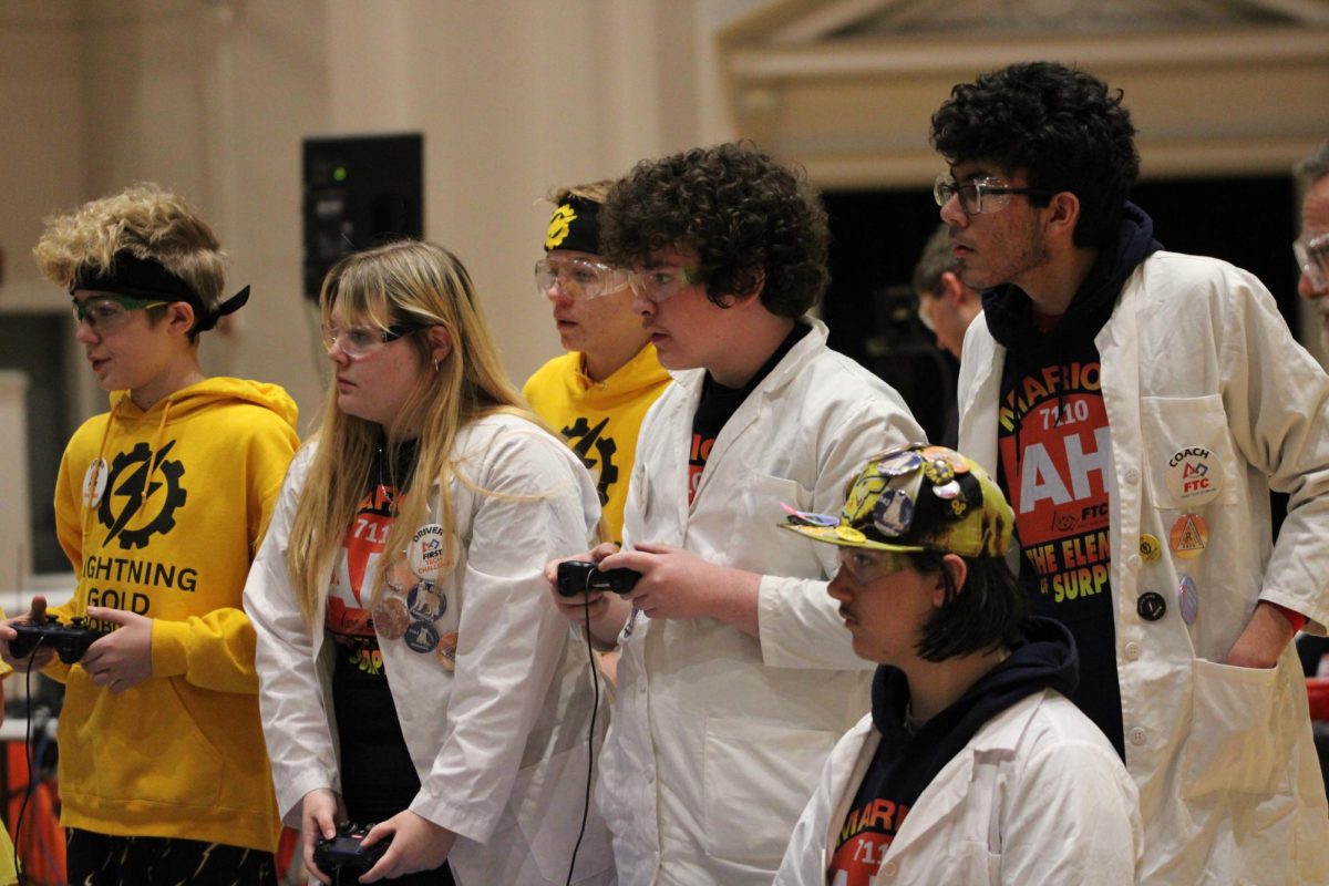 Members of The Element of Surprise compete at Veteran's Memorial Building with their robot.
