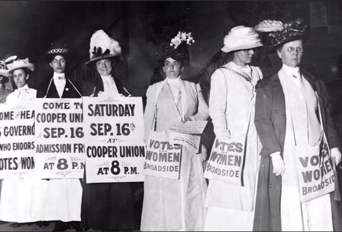 Women hold signs protesting the right to vote during the women's suffrage movement, dating back to the 1820’s. (Courtesy of History)