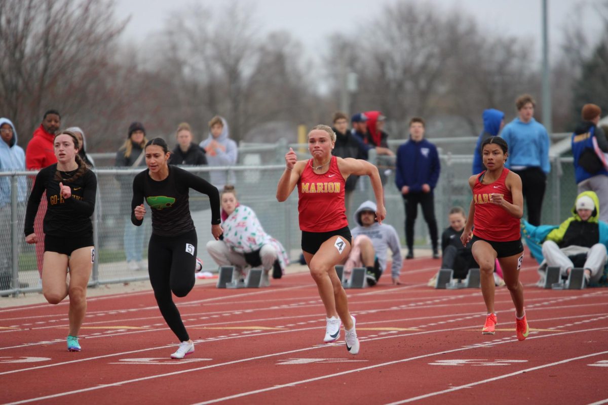 Abby Cave, '26, and Imari Michaels, '27, sprint for the finish line at the home meet.