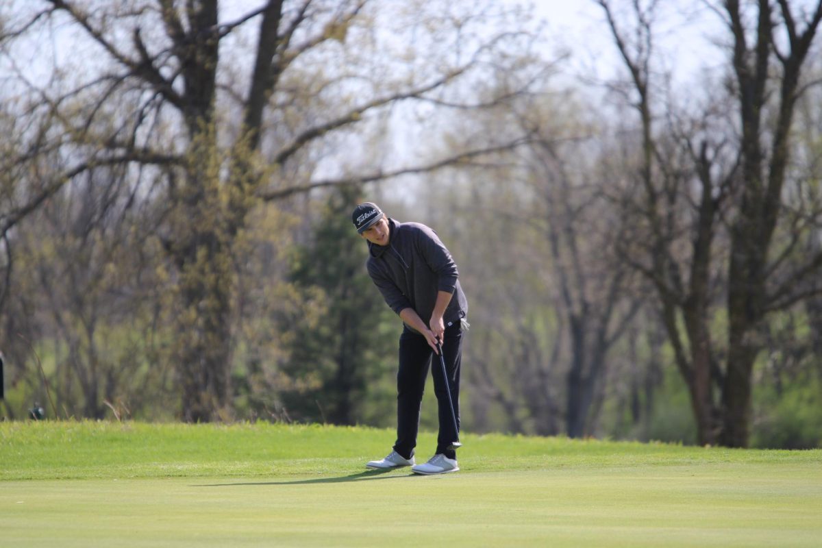 Jackson Rinderknecht, '26, watches the ball after an important putt.