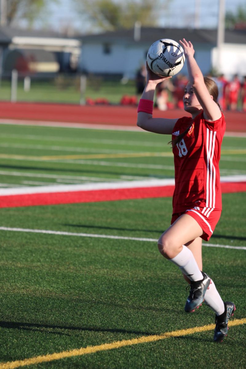 Lily Cowdin, '27, tosses in the ball to begin play.